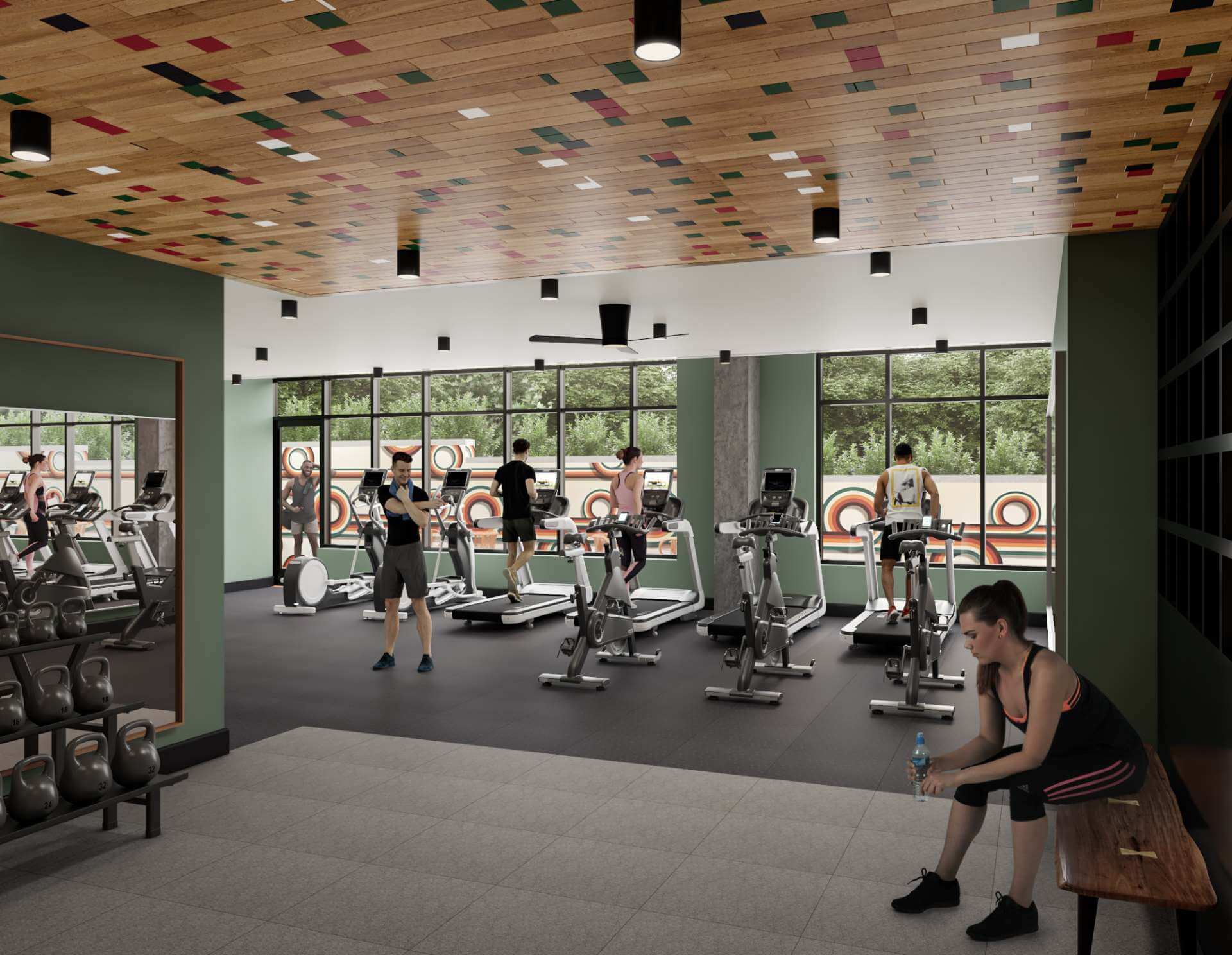fitness center with kettlebells and treadmills in front of large windows